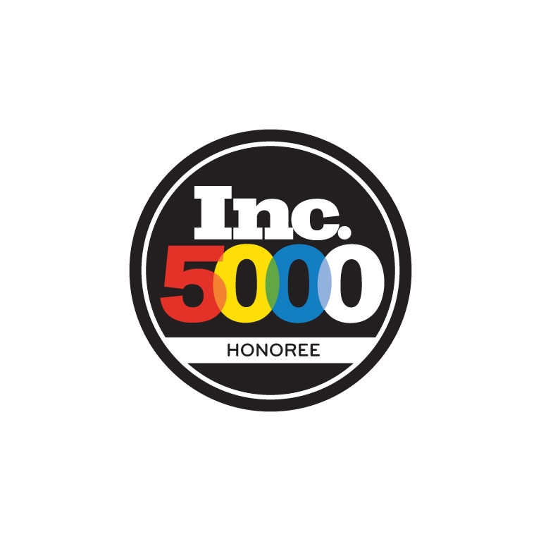 A circular badge with Inc. 5000 in bold, overlapping red, yellow, and blue numbers and letters, and HONOREE in black text below on a white background.