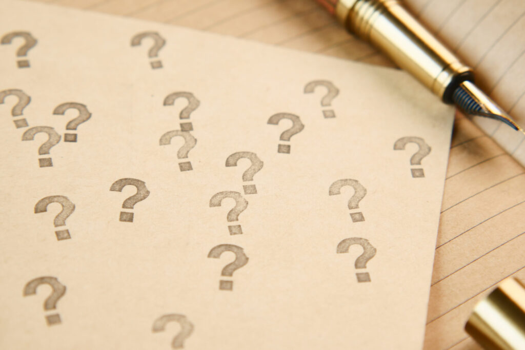 A paper with question marks on it.