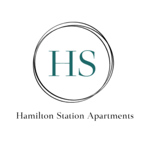 A logo with the letters HS inside a double-line circle, with the text Hamilton Station Apartments below it. The design is simple and uses teal and black on a white background.