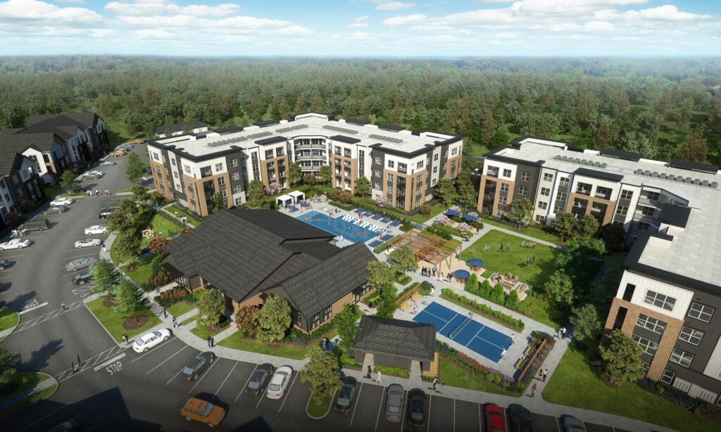 Aerial view of a modern apartment complex with a central pool, outdoor seating areas, tennis courts, green spaces, and parked cars. Surrounding buildings are surrounded by trees and a forested area in the background.