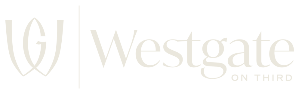 Light beige logo with a stylized W on the left and the words Westgate on Third on the right.